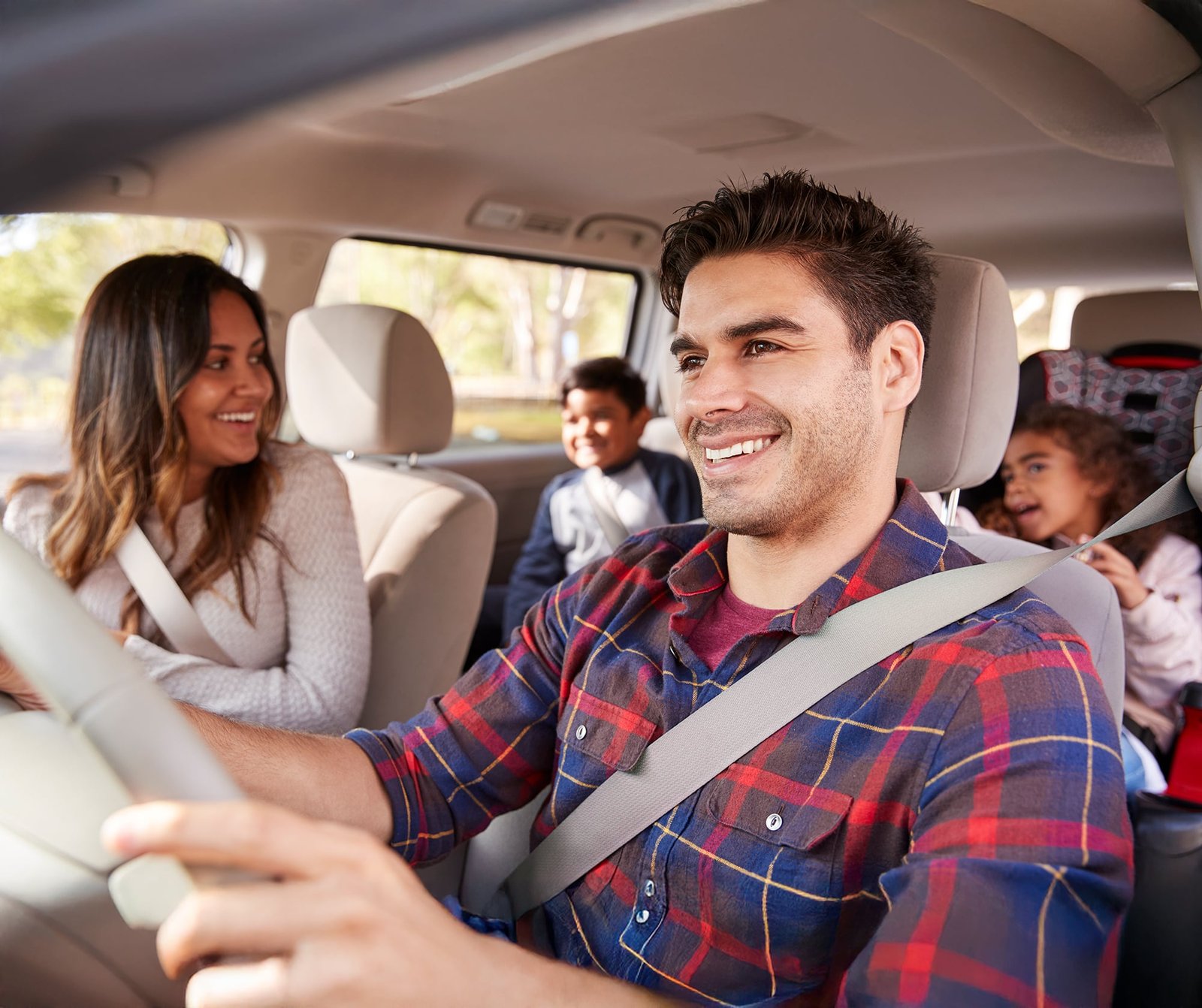 Happy family driving in car